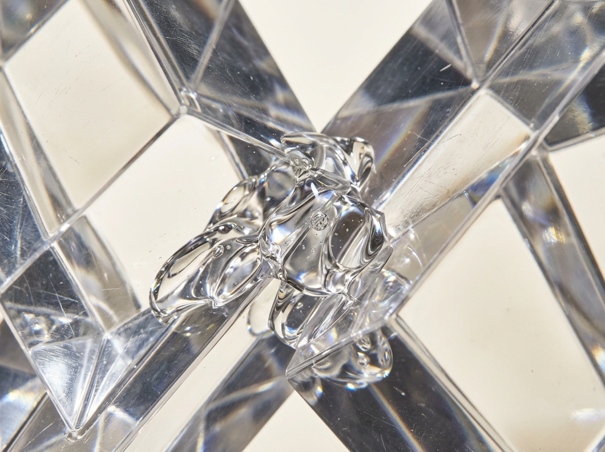 Clear liquid glue with tiny air bubbles connects the faceted edges of intersecting transparent geometric blocks.